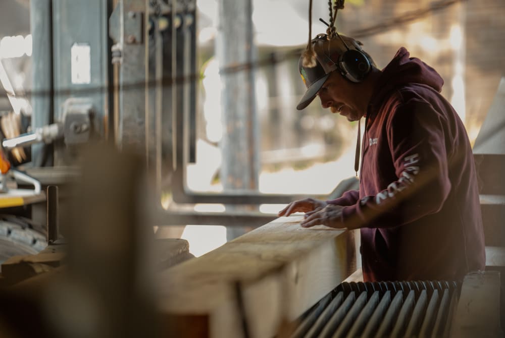 Haselton Lumber team member re-working a timber in the mill shop